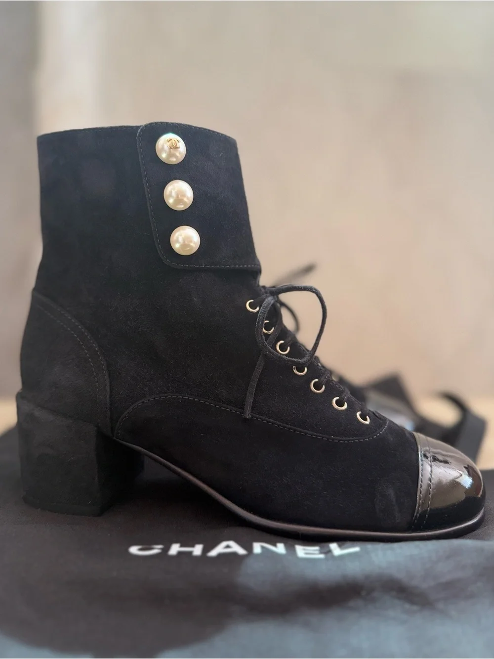 CHANEL Black Suede Lace-Up Ankle Boots with Patent Cap Toe and Pearl Buttons